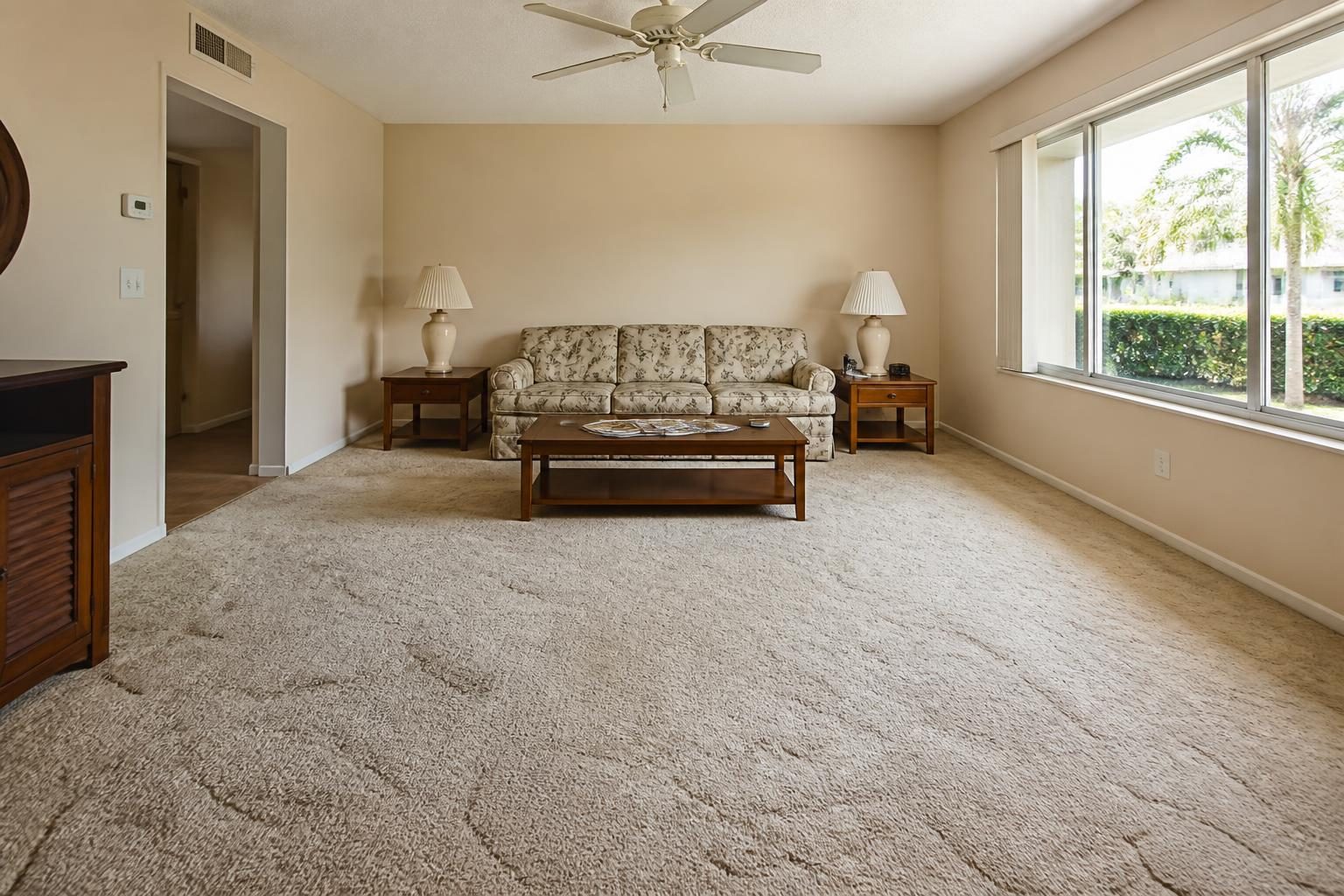 Dated Florida living room with old carpet before flooring renovation